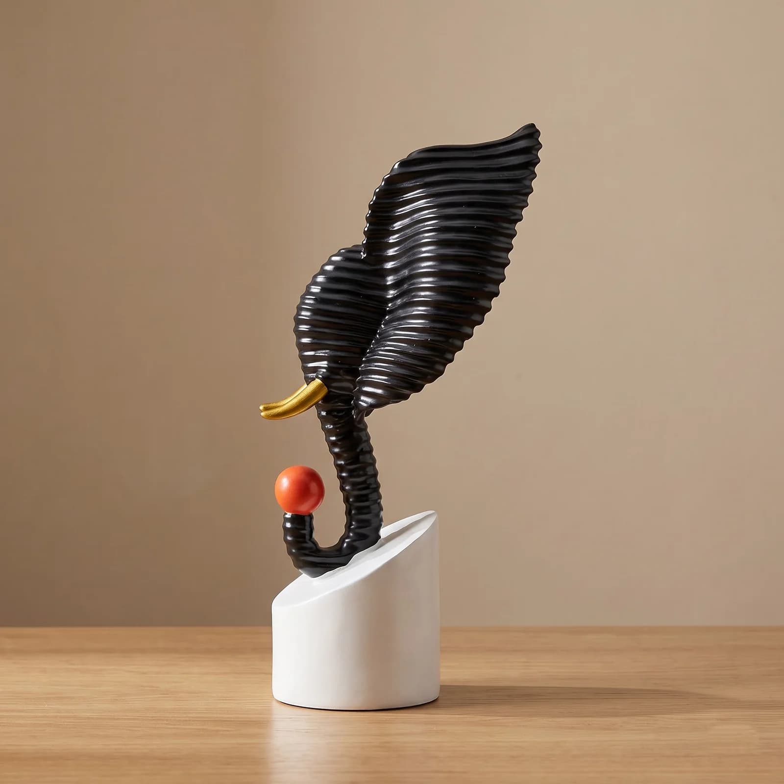 Abstract black textured elephant head sculpture holding a red ball, displayed on a modern living room side table over decorative books preview 3